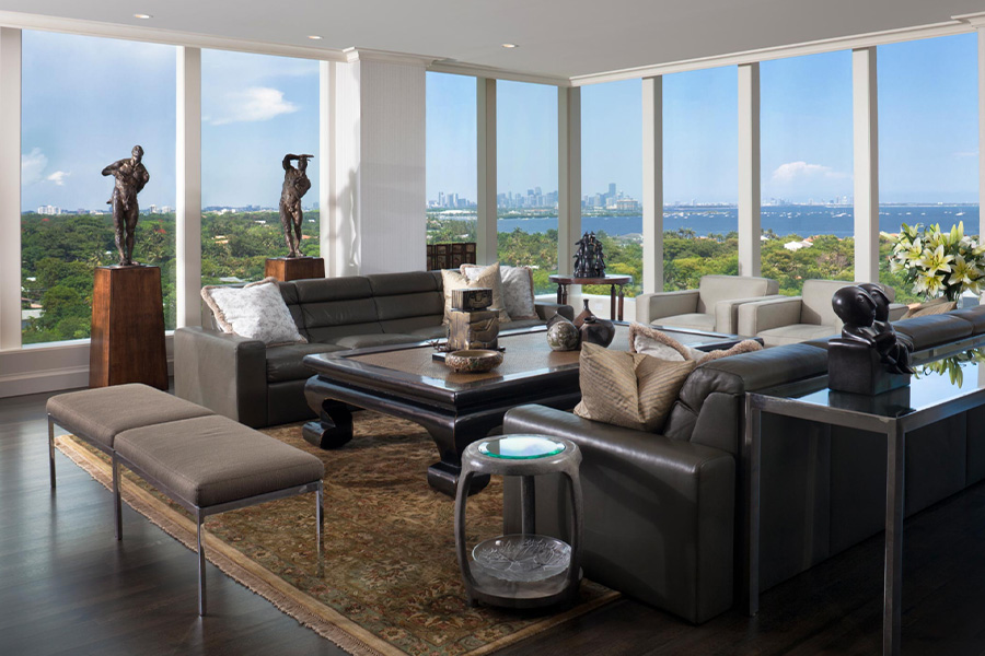 living room with floor to ceiling windows and a view of water and city skyline